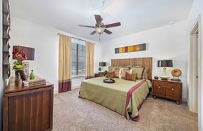 San Antonio apartment for rent - a bedroom with a large bed and a ceiling fan