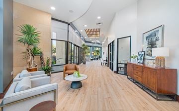 Mckinney apartment for rent - a long living room with a couch and a table