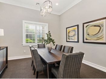 Gorgeous dining room space with elegant lighting and wood plank flooring