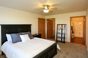 Kiel apartment for rent - a bedroom with a large bed and a ceiling fan