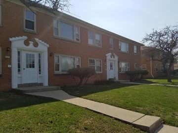 Milwaukee apartment for rent - an apartment building with white doors and a sidewalk