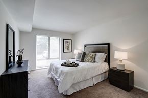 Reston apartment for rent - a bedroom with a large bed and a window