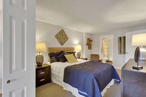 Denver apartment for rent - a bedroom with a bed and a dresser