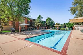 Denver apartment for rent - a swimming pool with a building in the background