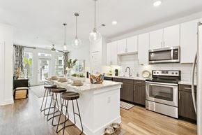 Jacksonville apartment for rent - A modern kitchen with white cabinets and a center island.