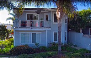 Laguna Beach triplex for rent - a white house with a balcony and a palm tree