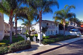 Laguna Beach triplex for rent - a street with palm trees in front of houses