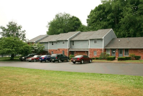 Mercer apartment for rent - A building with a parking lot in front of it.
