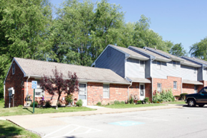 Mercer apartment for rent - A row of houses with a car parked in front of the first one.