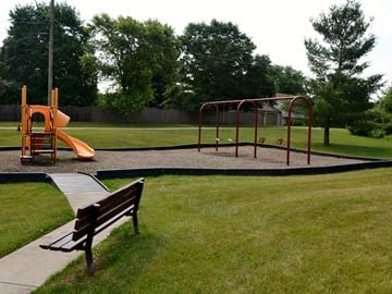 Gettysburg apartment for rent - A playground with a slide, swings, and a bench.