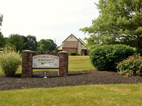Gettysburg apartment for rent - A sign for Gettysburg Place Apartments is in front of a building.