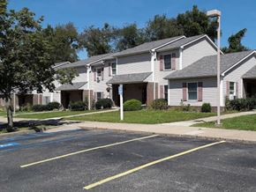 Harrison City apartment for rent - Apartment building with a parking lot in front.