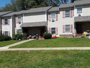 Harrison City apartment for rent - Apartment building with a red car parked in the driveway.