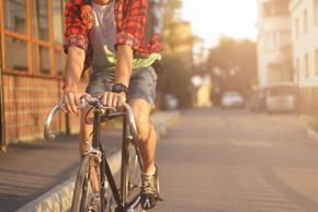 Harrison City apartment for rent - A man riding a bike on a sidewalk.