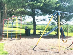 Snow Hill apartment for rent - A playground with a yellow slide and a red and yellow climbing frame.