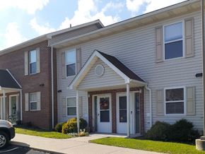 Saxonburg apartment for rent - the front of a white and brick apartment building