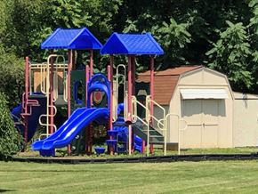 Martinsburg apartment for rent - A playground with a blue slide and a red and blue structure.