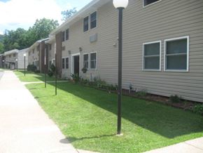 Pineville apartment for rent - a row of houses with a sidewalk and grass