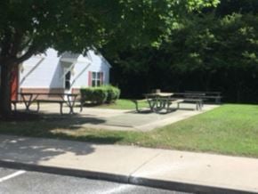 Hebron apartment for rent - A park with picnic tables and a house in the background.
