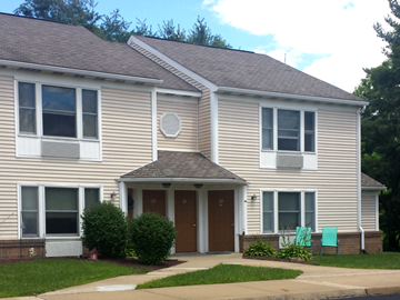 Finleyville apartment for rent - A two-story house with a brown door and a small porch.