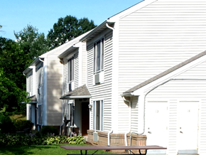 Finleyville apartment for rent - A white house with a wooden bench in front.