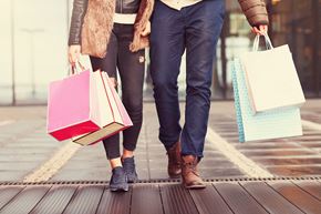 Finleyville apartment for rent - A man and woman walking together carrying shopping bags.