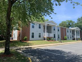 Emporia apartment for rent - an apartment building with a parking lot and a tree