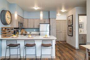 Maple Valley apartment for rent - Kitchen featuring white quartz countertop island with breakfast bar.