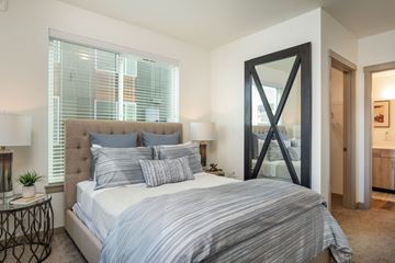 Maple Valley apartment for rent - a bedroom with a large bed and a mirror