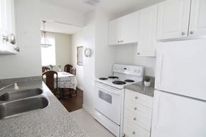 Burlington apartment for rent - A kitchen with white appliances and cabinets.