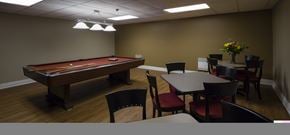 Burlington apartment for rent - A pool table with a red cloth and a flower arrangement on the side table.