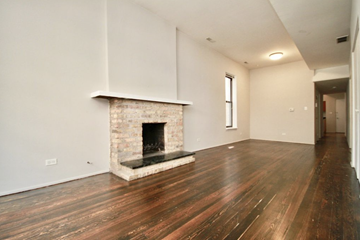 Chicago apartment for rent - the living room has a stone fireplace and hardwood floors