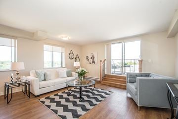 Kitchener apartment for rent - A living room with a white couch and a coffee table.