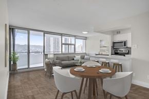 Hamilton apartment for rent - A dining room with a table set for six with a view of the city.