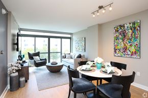 Washington apartment for rent - A dining room with a table set for six and a painting on the wall.