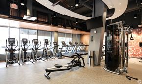 Washington apartment for rent - A gym with a variety of equipment including treadmills, weights, and exercise machines.