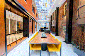 Washington apartment for rent - a large room with a wooden table and yellow benches