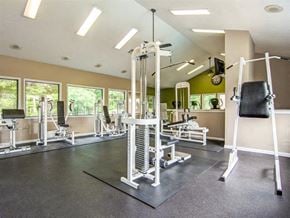 Sandy Springs apartment for rent - a gym with a lot of weights and a chair