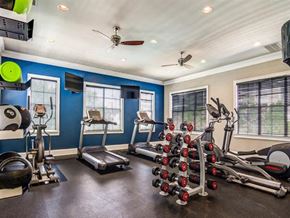 Atlanta apartment for rent - a home gym with exercise equipment and a ceiling fan