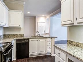 Atlanta apartment for rent - a kitchen with white cabinets and a stove and a sink