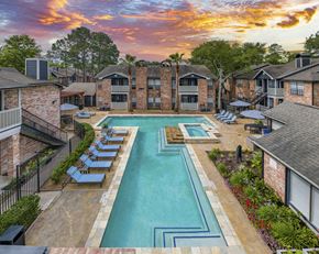 The Woodlands apartment for rent - an aerial view of an apartment complex with a pool and lounge chairs