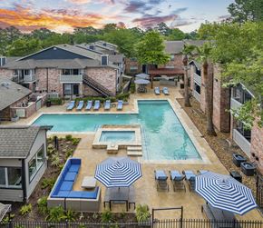 The Woodlands apartment for rent - an aerial view of a swimming pool and patio with umbrellas