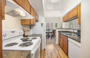 The Woodlands apartment for rent - a kitchen with white appliances and wooden cabinets