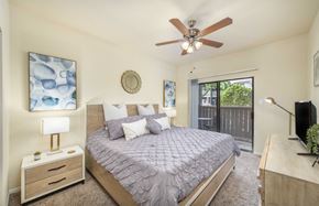 The Woodlands apartment for rent - a bedroom with a bed and a ceiling fan
