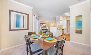 Houston apartment for rent - a dining area with a table and chairs and a kitchen in the background