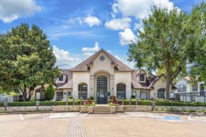 Houston apartment for rent - the front of a house with trees and a driveway