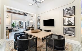 Cypress apartment for rent - a dining room with a wooden table and black chairs