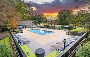 Simpsonville apartment for rent - A beautiful outdoor swimming pool area with lounge chairs and a sunset view.