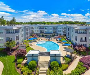 Greenville apartment for rent - an aerial view of an apartment complex with a swimming pool