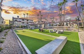 Scottsdale apartment for rent - a yard with grass and chairs and a sunset in the background